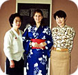 The summer kimono I'm wearing was made for, given to and put on me by the mother of the woman at right; both the women were students of mine. Photographer unknown