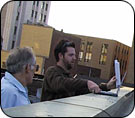 Ben Hockenhull and Delmar Brimble survey the area for Wi-Fi signals from the roof of the Regional Arts Commission